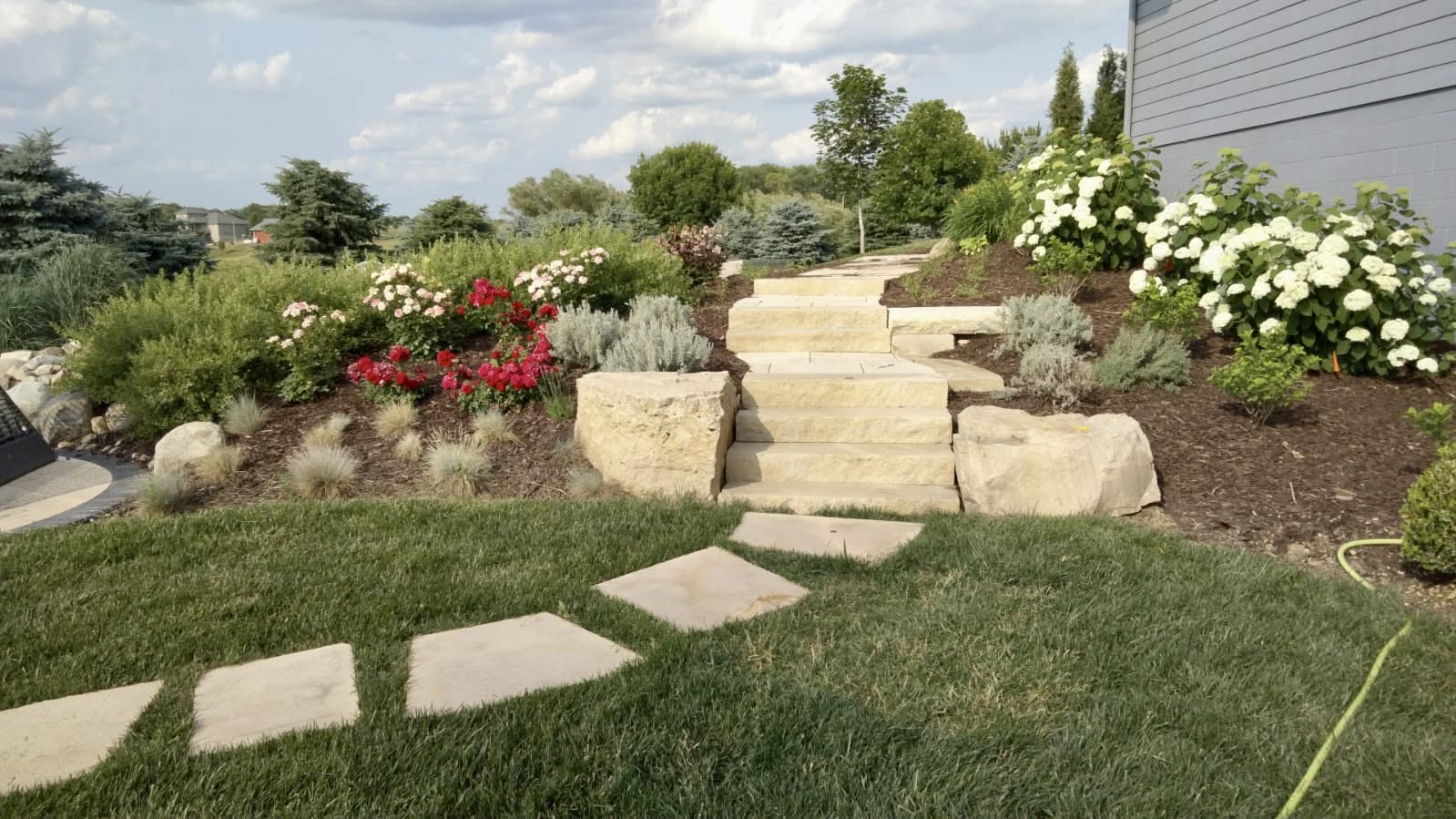 Stone steps and a landscaped garden by Memo's in Omaha, Nebraska